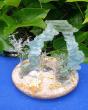 Energy magical portal 
Portail en verre bleu/vert . Fusion de plaque . Filage au chalumeau sur socle bois et liège recyclés agrémenté de poudre de verre de plusieurs calibres.
15 cm Haut . 18 cm diam. 