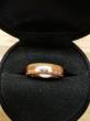 Bague en palissandre avec incrustation d'un fil de cuivre arrêté sur 4 mm pour y loger 10 petits fragments de pierres rapportées de 10 destinations différentes. 


